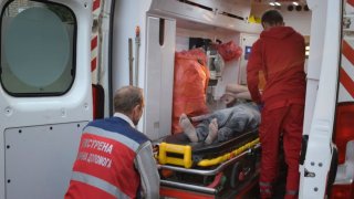 In this photo provided by the National Police of Ukraine, paramedics move an injured man into an ambulance near the restaurant RIA Pizza destroyed by a Russian attack in Kramatorsk, Ukraine, Tuesday, June 27, 2023.