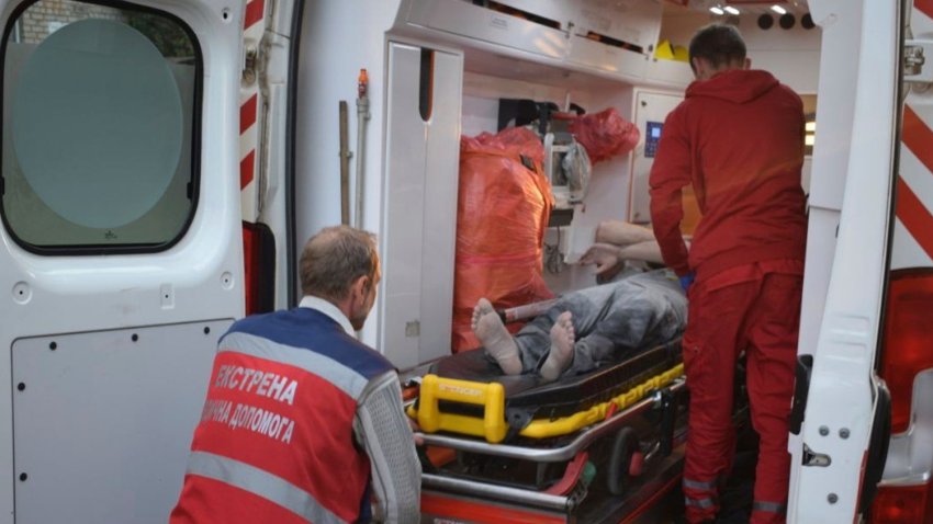 In this photo provided by the National Police of Ukraine, paramedics move an injured man into an ambulance near the restaurant RIA Pizza destroyed by a Russian attack in Kramatorsk, Ukraine, Tuesday, June 27, 2023.