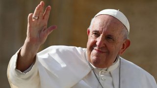 Pope Francis (L) waves at the end of his weekly general audience at Saint Peter’s Square in the Vatican on October 26, 2022.