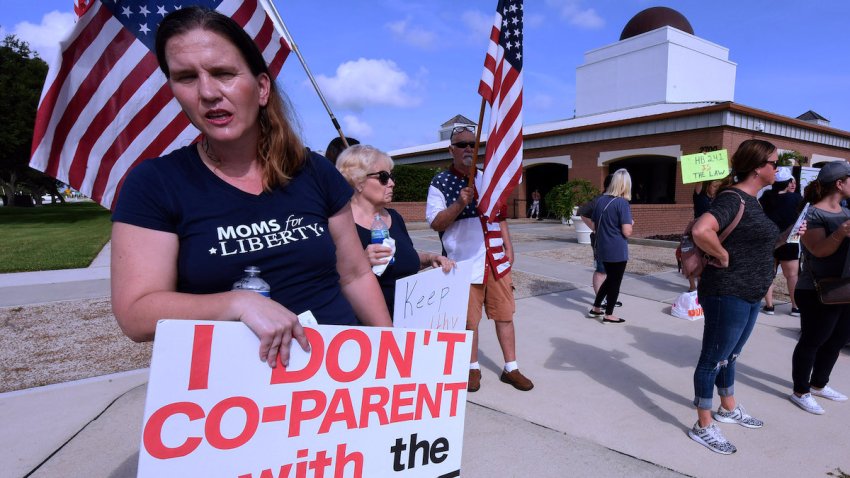 VIERA, FLORIDA, UNITED STATES – 2023/06/07: A member of Moms for Liberty protests against mandatory face masks for students during the COVID-19 pandemic at a meeting of the Brevard County School Board in Viera. The Southern Poverty Law Center (SPLC) is for the first time labeling Florida-headquartered Moms for Liberty and 11 other right-wing “parents’ rights” groups as anti-government extremist groups in its annual report, released on June 6, 2023. (Photo by Paul Hennessy/SOPA Images/LightRocket via Getty Images)