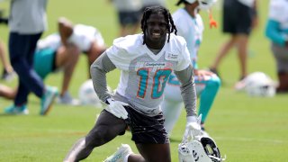 MIAMI GARDENS, FLORIDA – JUNE 08: Tyreek Hill #10 of the Miami Dolphins stretches prior to practice at Baptist Health Training Complex on June 08, 2023 in Miami Gardens, Florida.