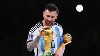 Lionel Messi of Argentina celebrates with the World Cup Trophy and player of the tournament award during the FIFA World Cup Qatar 2022 Final match between Argentina and France at Lusail Stadium on December 18, 2022 in Lusail City, Qatar.