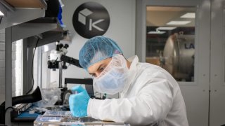 Senior satellite technician Chris Summers completes the final pre-flight checks on satellites Kepler-16 and Kepler-17.
