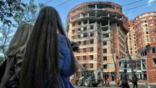 Two women watch the response effort to a recent missile attack of the Russian troops on Odesa, southern Ukraine. As reported, the Russian occupation army launched four Kalibrs at civilian infrastructure in Odesa Wednesday night, June 14. 