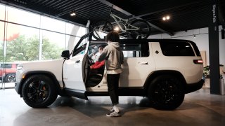 People walk by electric truck maker Rivian’s newly opened storefront in the Meatpacking District of Manhattan on June 23, 2023 in New York City.