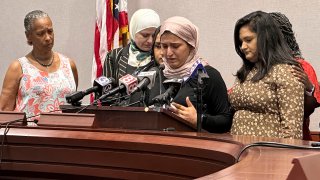 Connecticut state Rep. Maryam Khan, second from right, with her right arm in a sling in Hartford, Conn., Thursday July 6, 2023.