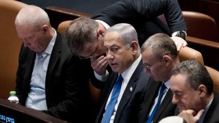 Lawmakers surround Israel’s Prime Minister Benjamin Netanyahu, center, at a session of the Knesset, Israel’s parliament, in Jerusalem, Monday, July 24, 2023.