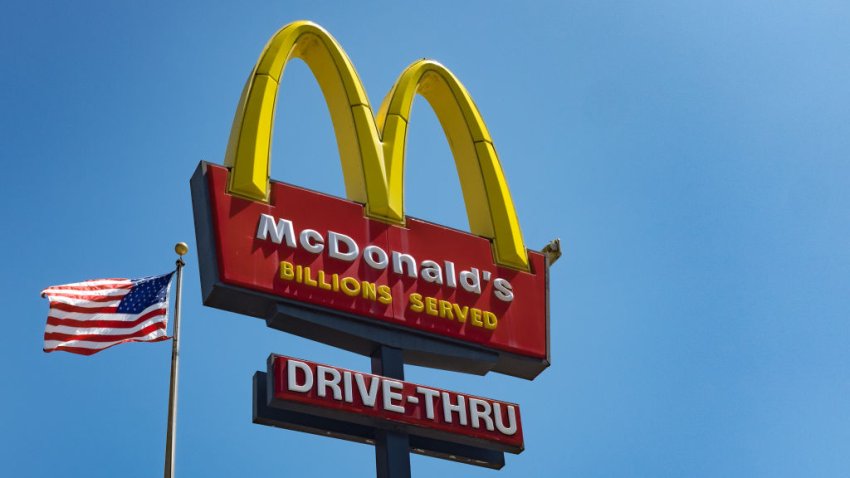 FILE – The sign for McDonald’s drive in take-away restaurant and an American flag in the Silver Lake area of Los Angeles.