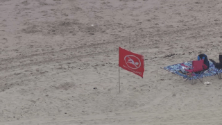 Red flag in sand at Rockaway Beach.