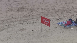 Red flag in sand at Rockaway Beach.