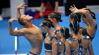 Bill May, left, leads the United States team out to compete in the team acrobatic of artistic swimming at the World Swimming Championships in Fukuoka, Japan, on Saturday, July 15, 2023.