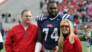 FILE - Michael Oher, No. 74 of the Ole Miss Rebels, stands with Sean and Leigh Anne Tuohy during senior ceremonies prior to a game against the Mississippi State Bulldogs at Vaught-Hemingway Stadium on Nov. 28, 2008 in Oxford, Miss.