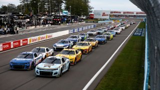 Kyle Larson, driver of the No. 5 HendrickCars.com Chevrolet, and Chase Elliott, driver of the No. 9 Kelley Blue Book Chevrolet, lead the field during the NASCAR Cup Series Go Bowling at The Glen at Watkins Glen International on Aug. 21, 2022 in Watkins Glen, N.Y.