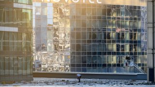 Investigators examine an area next to damaged building in the “Moscow City” business district after a reported drone attack in Moscow, Russia, early Tuesday, Aug. 1, 2023. Ukrainian drones again targeted Moscow and its surroundings early Tuesday morning, the Russian military reported. Two of three launched were shot down outside Moscow, while one crashed into a skyscraper in the Moscow City business district, damaging the building’s facade.