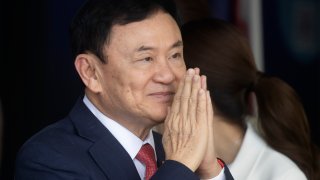 Thailand’s former Prime Minister Thaksin Shinawatra greets supporters on his arrival at Don Muang airport in Bangkok, Thailand, Tuesday, Aug. 22, 2023.