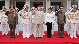 This photo provided on Tuesday, Aug. 29, 2023, by the North Korean government, North Korean leader Kim Jong Un, center, with his daughter, center right, reportedly named Ju Ae, review the honor guard during their visit to the navy headquarter in North Korea, on Aug. 27, 2023.