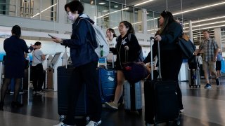 Travelers walk through Terminal 3 at O’Hare International Airport in Chicago, Thursday, Aug. 31, 2023.