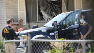 FBI agents at the home of Craig Robertson, who was shot and killed by the FBI on August 9, 2023, in Provo, Utah. ,