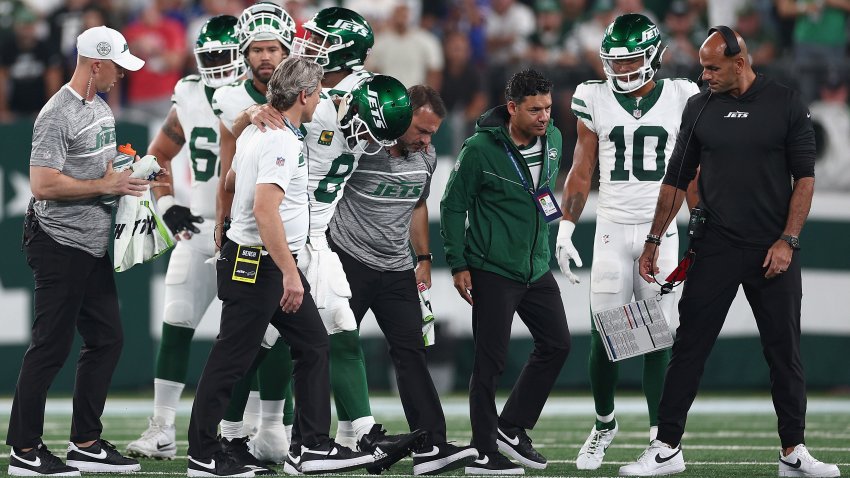 Quarterback Aaron Rodgers of the New York Jets is helped off the field by team trainers after an injury during the first quarter of the NFL game against the Buffalo Bills at MetLife Stadium on Sept. 11, 2023 in East Rutherford, N.J.