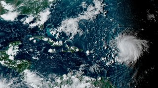 This satellite image provided by the National Oceanographic and Atmospheric Administration shows Hurricane Lee, right, in the Atlantic Ocean on Friday, Sept. 8, 2023,