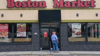 A man reads a stop work order posted on the door of a Boston Market restaurant in Hackensack, N.J., Aug. 17, 2023.