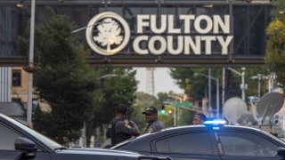 Police outside the Fulton County Courthouse in Atlanta, Georgia, US, on Tuesday, Aug. 15, 2023. Donald Trump and some of his top administration officials and associates were indicted in Atlanta over efforts to overturn the results of his 2020 election defeat in Georgia, the fourth criminal case against the former president as he campaigns for the White House.