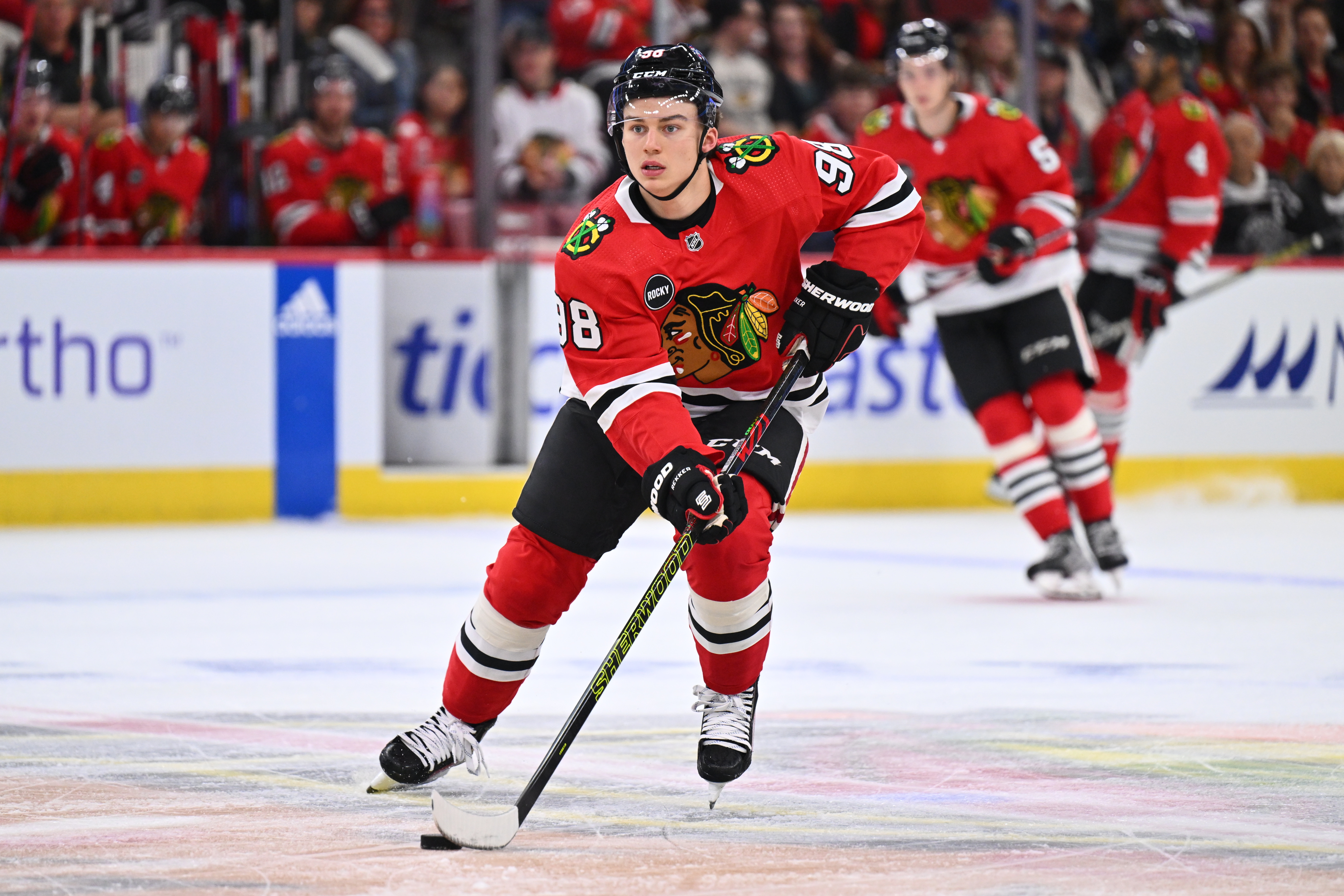 Sep 28, 2023; Chicago, Illinois, USA; Chicago Blackhawks forward Connor Bedard (98) skates the puck up ice in the first period against the St. Louis Blues at United Center. Mandatory Credit: Jamie Sabau-USA TODAY Sports