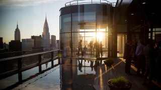 Guests attend a pool party in the penthouse apartment at the 50 United Nations Plaza building in New York.