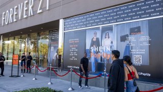 Shoppers walks past advertisements on the opening day of fast fashion e-commerce giant Shein, which is hosting a brick-and-mortar pop up inside Forever 21 at the Ontario Mills Mall in Ontario Thursday, Oct. 19, 2023. 