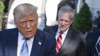 Mark Meadows, White House chief of staff, listens as President Donald Trump, left, speaks to members of the media before boarding Marine One on the South Lawn of the White House in Washington, D.C., July 29, 2020.