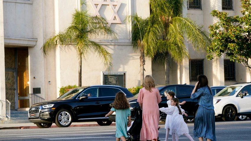 Mothers and daughters walk across the Congregation Shaarei Tefila synagogue in Los Angeles on Saturday, Oct. 7, 2023.  (AP Photo/Damian Dovarganes)