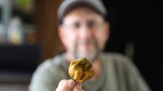 Ed Currie holds up one of his Pepper X peppers on Oct. 10, 2023, in Fort Mill, S.C.