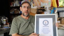 Ed Currie holds up his certification that his new Pepper X variety of peppers is the hottest in the world according to the Guinness Book of World Records on Tuesday, Oct. 10, 2023, in Fort Mill, S.C.