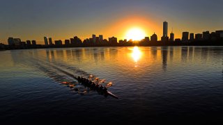 Boston, MA – October 21: A morning sunrise lights up an eight person rowing scull on the Charles River for day one of the Head of the Charles Regatta. (Photo by David L. Ryan/The Boston Globe via Getty Images)