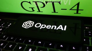 GPT-4 sign on website displayed on a laptop screen and OpenAI logo displayed on a phone screen are seen in this illustration photo taken in Poland on March 14, 2023.