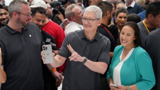 Apple CEO Tim Cook holds a new iPhone 15 Pro during the Wonderlust project launch event at the company’s headquarters in Cupertino, California, Sept. 12, 2023.