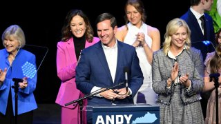 Kentucky incumbent Democratic Gov. Andy Beshear is joined by his wife, Britainy Beshear (R), Kentucky Lt. Governor Jacqueline Coleman (C-L) and his family as he delivers his victory speech to a crowd at an election night event at Old Forrester’s Paristown Hall on November 7, 2023 in Louisville, Kentucky.