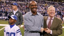 Former Colt Marvin Harrison was honored at halftime by the Colts. Here Harrison is with Colts Vice Chairman Bill Polian and his son Marvin Harrison Jr. Peyton Manning is back left. in their game on Sunday, November 27, 2011, in Indianapolis, Indiana. The Panthers won the game 27-19.  (Sam Riche/Tribune News Service via Getty Images)