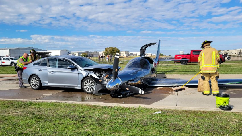 This photo provided by the McKinney Fire Department shows officials at the site of a crash involving a small plane and a vehicle near Aero Country Airport, Saturday, Nov. 11, 2023, in McKinney, Texas. Authorities say a small plane overshot the runway while trying to land at a Texas airport and struck a car that was driving along a nearby road, injuring one person.  (McKinney Fire Department via AP)