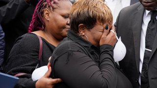 Bettersten Wade, mother of Dexter Wade, a 37-year-old man who died after being hit by a Jackson, Miss., police SUV driven by an off-duty officer, is comforted by her daughter, Latonya Moore, left, while watching her son’s body transferred to a mortuary transport, after being exhumed from a pauper’s cemetery near the Hinds County Penal Farm in Raymond, Monday, Nov. 13, 2023.