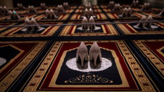 “Silence,” an installation by French Algerian artist Zoulikha Bouabdellah that displays 30 pairs of stiletto heels on the same number of Islamic prayer rugs.