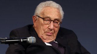 Henry Kissinger can be seen at a ceremony.