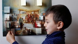 Boy opening an Advent calendar.