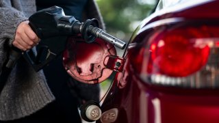 A driver pumps gas at a Sunoco gas station in Washington, DC, US, on Tuesday, Nov. 28, 2023. 