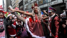 Revelers dressed as holiday characters participate in the annual SantaCon pub crawl on December 9, 2023 in New York City. While ostensibly raising money for charity, the event has been criticized for widespread drunkenness and sporadic violence. (Photo by Stephanie Keith/Getty Images)