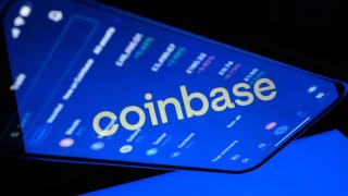 LONDON, ENGLAND – NOVEMBER 09: In this photo illustration, a flipped version of the Coinbase logo is reflected in a mobile phone screen on November 09, 2021 in London, England. The cryptocurrency exchange platform is to release its quarterly earnings today. (Photo illustration by Leon Neal/Getty Images)