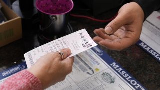 File photo: A customer purchases five Powerball tickets in Haverhill, Massachusetts.