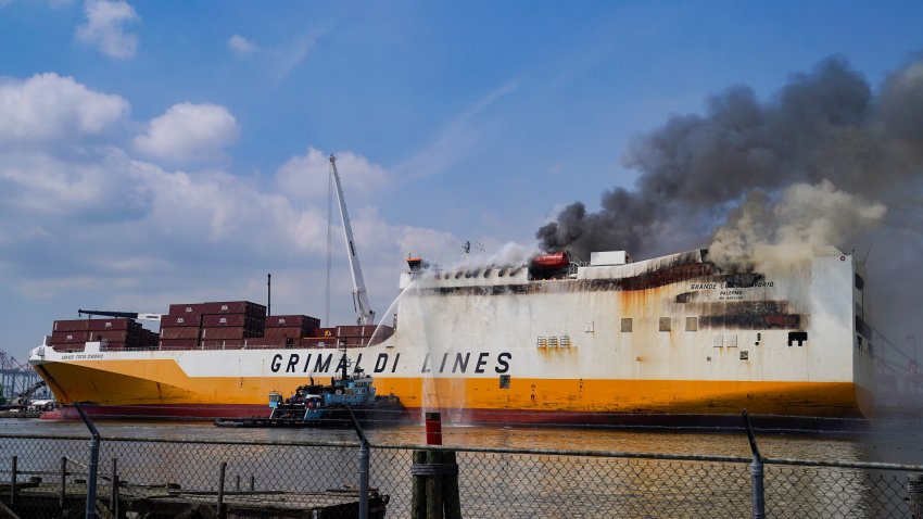 FILE – Emergency personnel battle against a fire aboard the Italian-flagged Grande Costa d’Avorio cargo ship at the Port of Newark, Friday, July 7, 2023, in Newark, N.J.   On Wednesday, Jan. 10, 2024, the U.S. Coast Guard and the National Transportation Safety Board began a series of investigative hearings into the cause of the fire, and plan to issue recommendations to avoid similar incidents in the future.(AP Photo/John Minchillo, File)