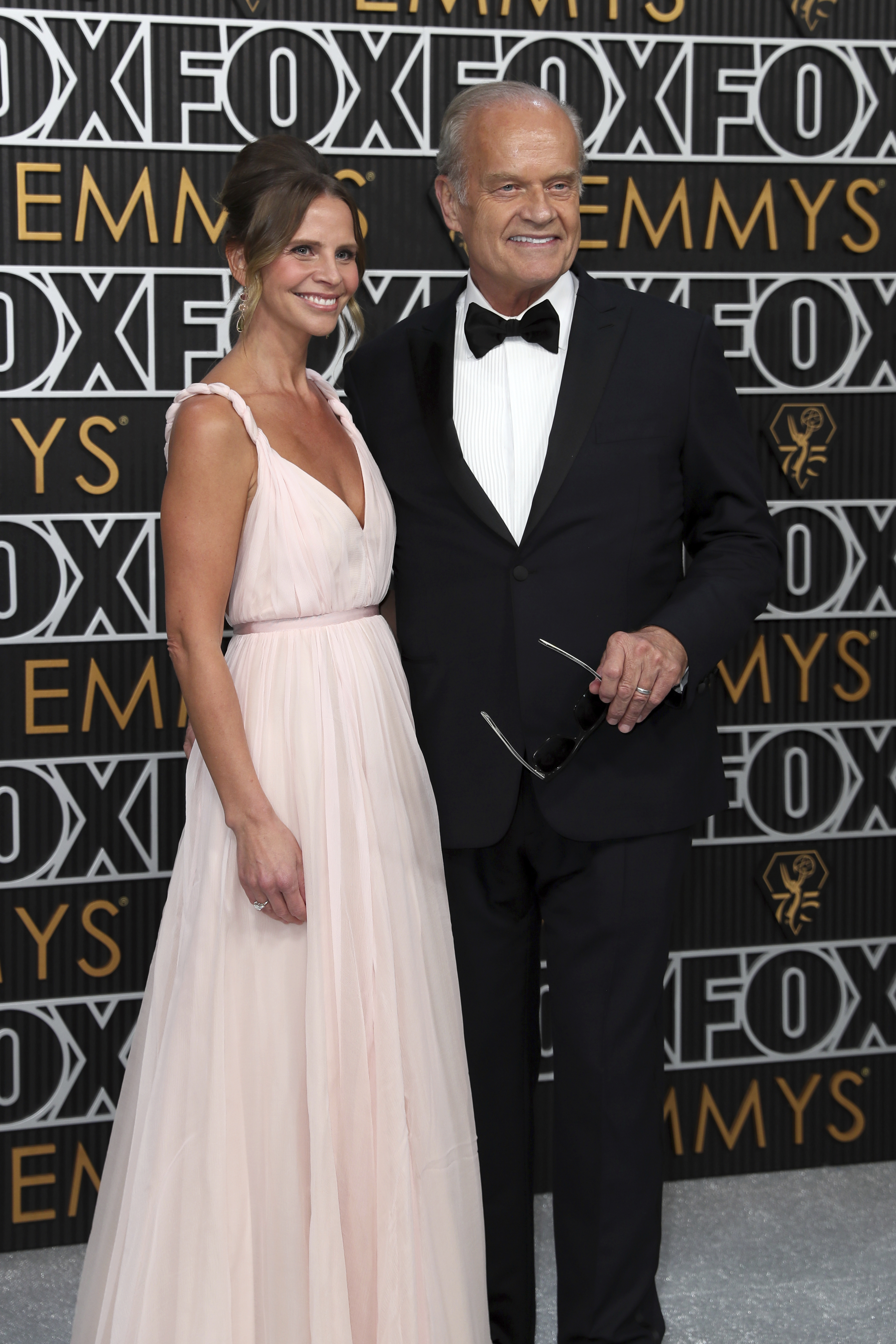 Kayte Walsh, left, and Kelsey Grammer pose for a Red Carpet portrait at the 75th Emmy Awards on Monday, Jan. 15, 2024 at the Peacock Theater in Los Angeles. (Photo by Danny Moloshok/Invision for the Television Academy/AP Images)