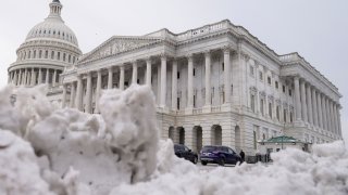 The U.S Capitol is photographed past piles of snow on Thursday, Jan. 18, 2024, in Washington.